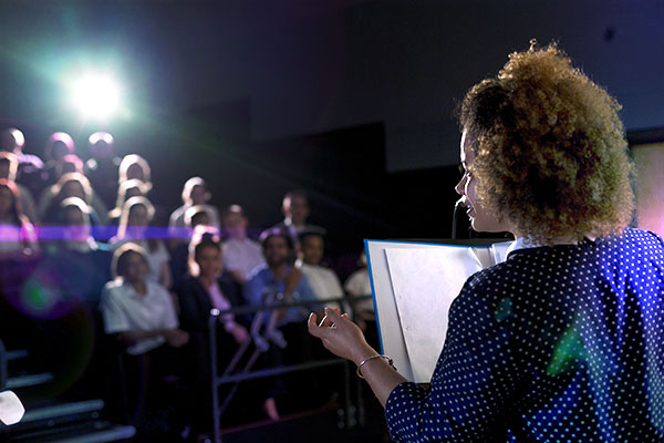 Person talking in front of an audience