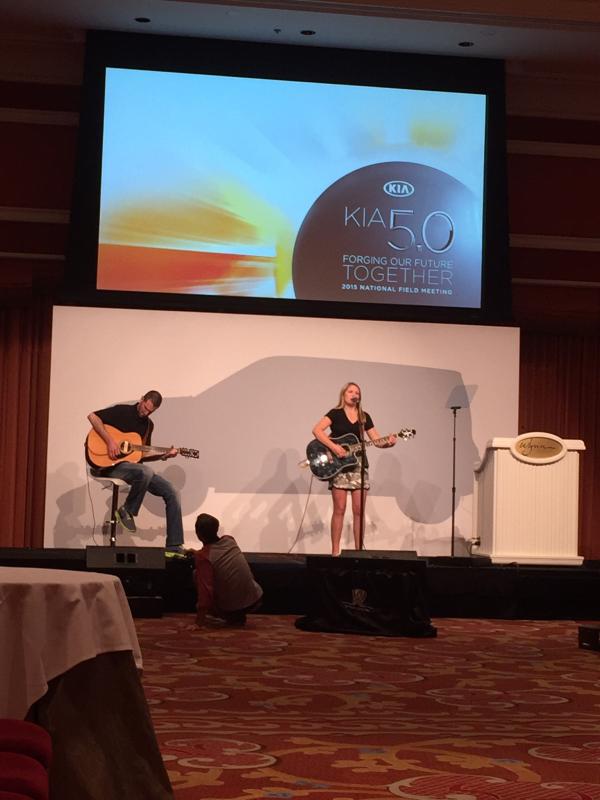 Emily Freeman performing on stage at the Kia convention