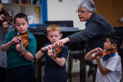 Karen Becker working with a student at the UNL/ LPS string project