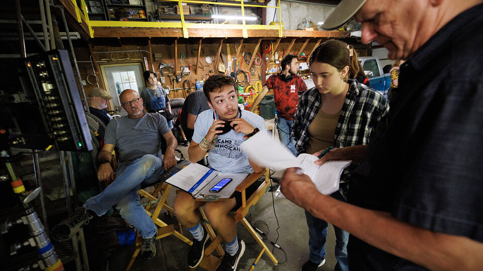 student and script supervisor Charlie Major listens to comments by producer Jamie Vesay. At left is Richard Endacott and in the middle right is Grace Birkland, Nebraska student and second assistant cameraperson. Photo by Craig Chandler.