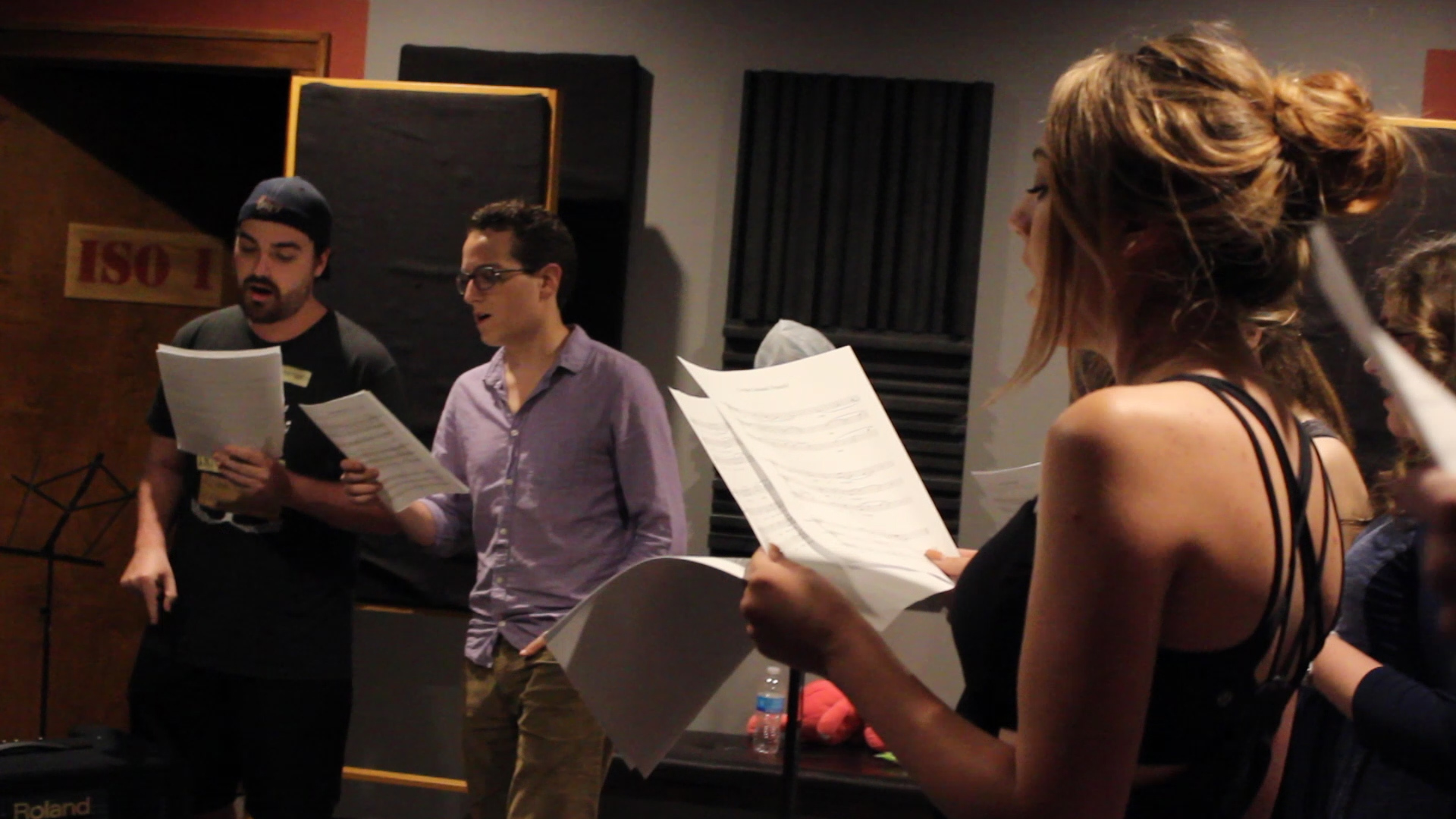 students singing in the recording studio