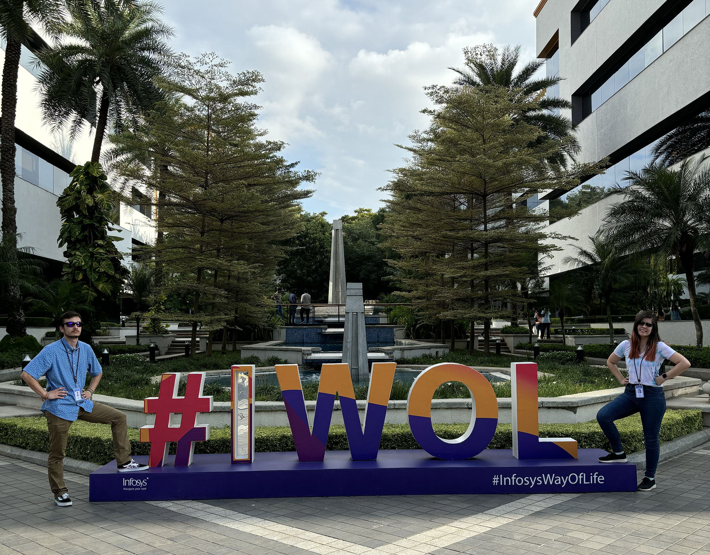 ajor and Megan Kolbe stand in front of the #IWOL (Infosys Way of Life) sign on the Infosys campus in India. Photo courtesy of Charles Major.