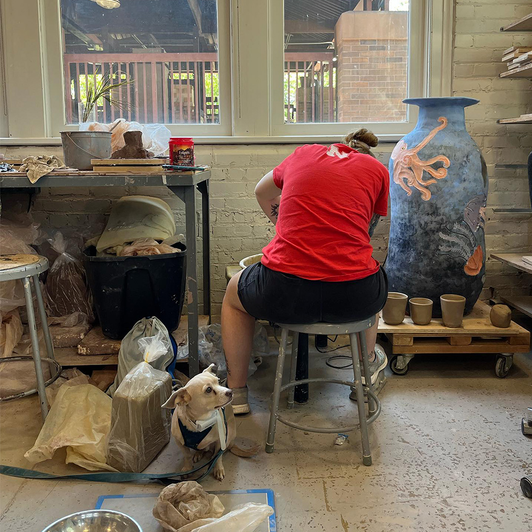 Ceramics student working in the studio on the wheel.