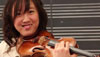 Photo of Janny Joo holding a violin