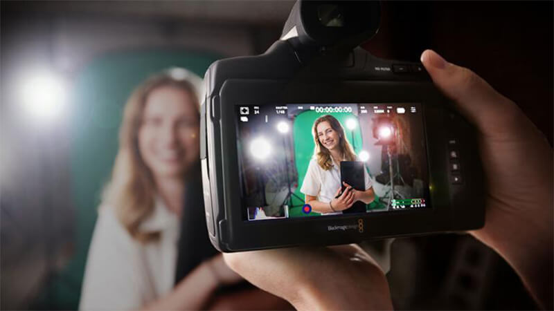 Student portrait through viewfinder of a camera