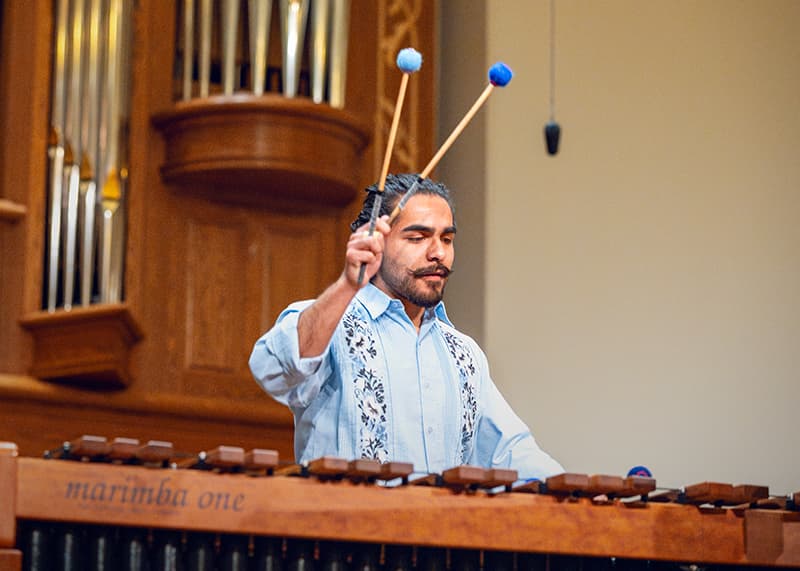 A percussionist holds mallets up ready to strike a note.