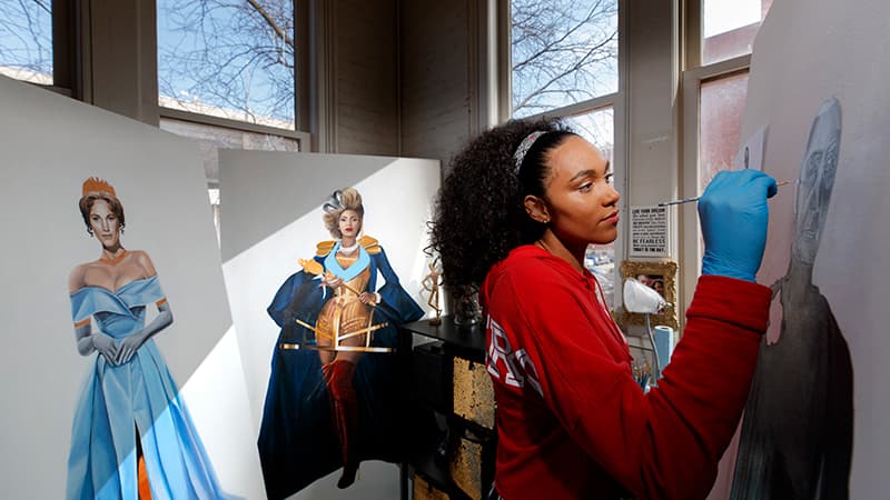 A student paints in the well-lit studios of Richards Hall.