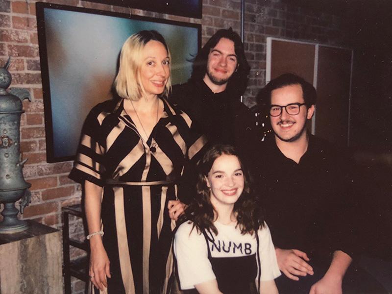 Three Carson Center students interning on a narrative film project pose for a photo with an Emerging Media Arts professor.