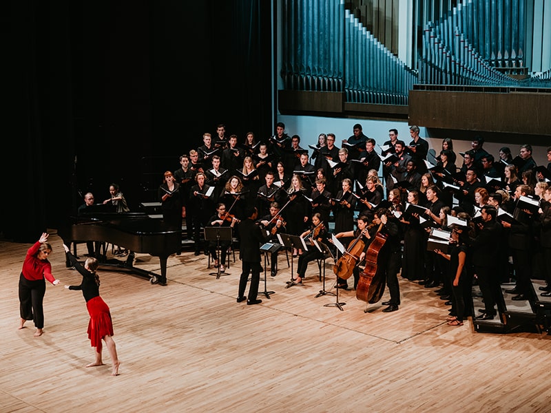 Music performance with orchestra and two dancers on stage