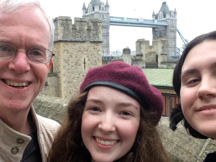 Two graduate students posing with Professor Clark Potter in Cambridge, England.