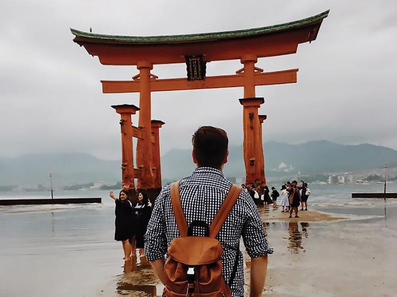 Carlos Velasco, a School of Art alum, looking out to a landmark in Japan while studying abroad.