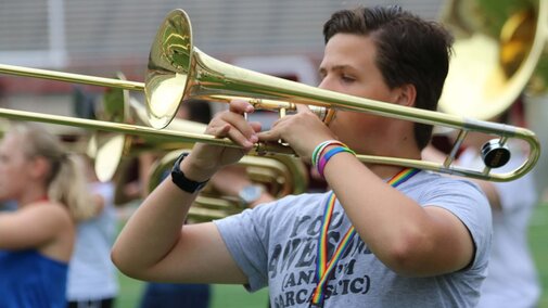 High school trombonist performing on the field