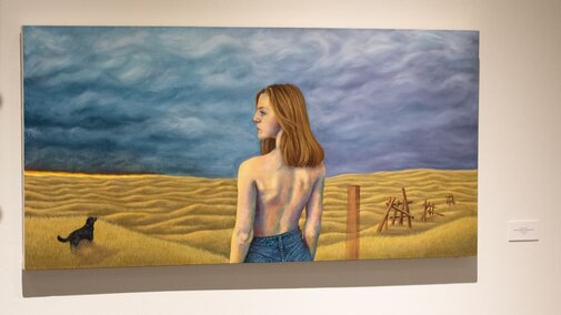 a painting of a woman amongst a wide landscape