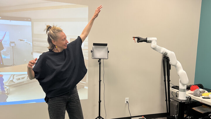 Ash Eliza Smith guides a robotic arm in the Speculative Robotics Lab. (Deann Gayman/University Communication and Marketing)