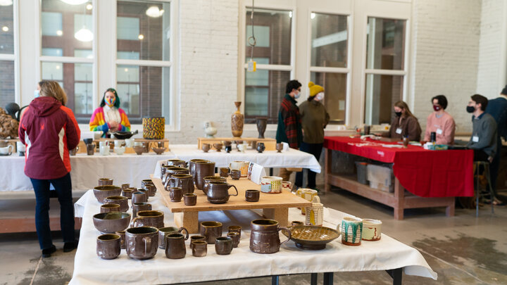 People browse work available for sale at last year's Clay Club sale. This year's sales, featuring work made by graduate and undergraduate students in ceramics, photography, printmaking and painting, are Dec. 9-10 in Richards Hall. Photo by Eddy Aldana.