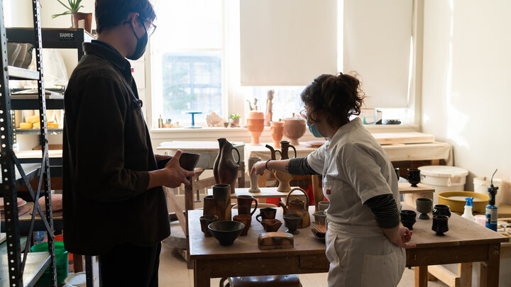 A visitor interacts with a graduate student at a previous Open Studios event. This yearâs Open Studios event is Nov. 3. Photo by Eddy Aldana.