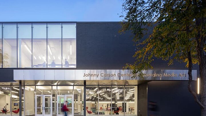 The exterior of the Johnny Carson Center for Emerging Media Arts building at dusk.