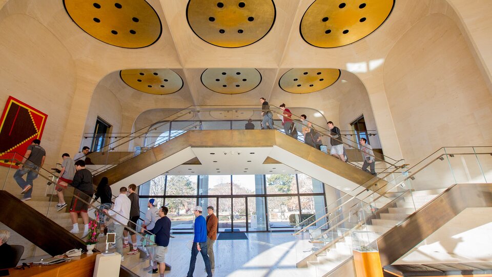Patrons climb the stairs on the interior of Sheldon Museum.