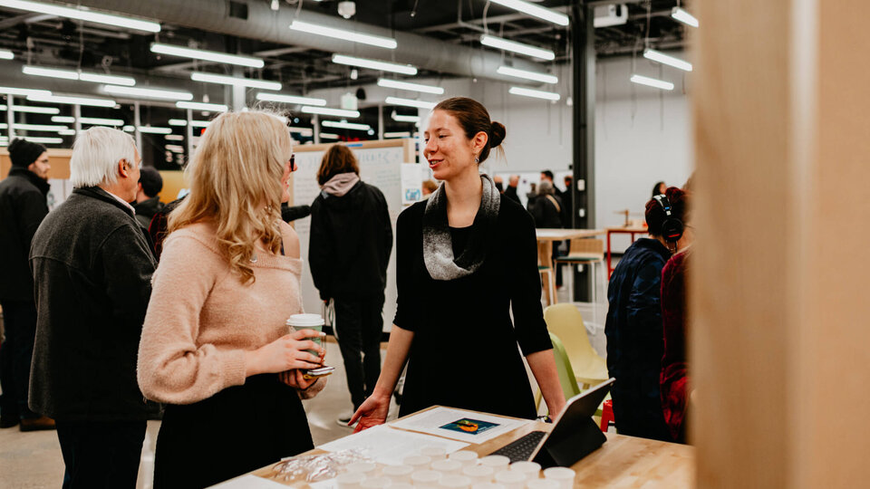 Student talking with open studio guest