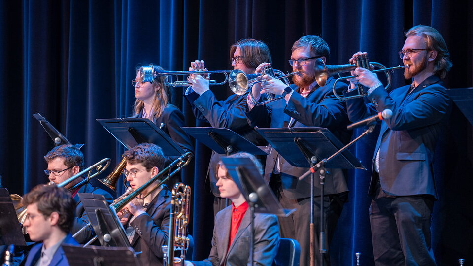 Jazz band musicians play on stage.