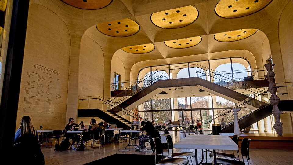 People sit at tables inside Sheldon Museum.