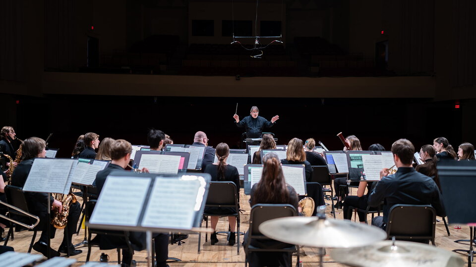 A symphony plays on stage