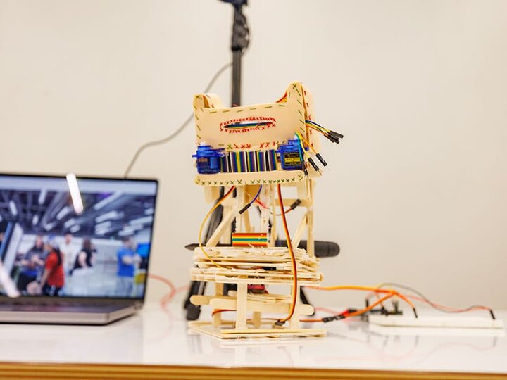 A structure hooked to a breadboard leading to a laptop.