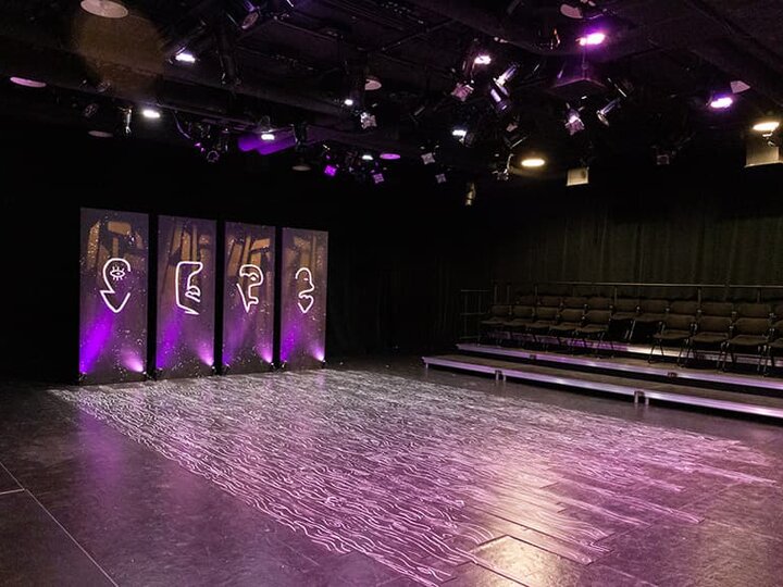 An empty stage lit with unique patterns.