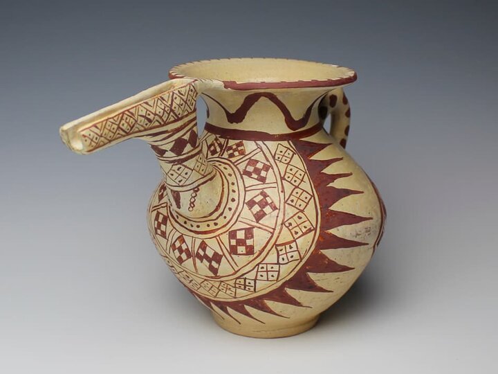 a curiously spouted pitcher