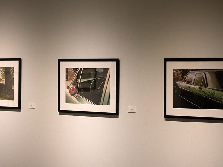 three framed images of a car hang on the gallery wall.