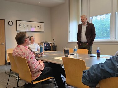 Ted Hunter visits with faculty and students during a lunch