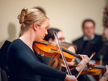 A woman plays violin.