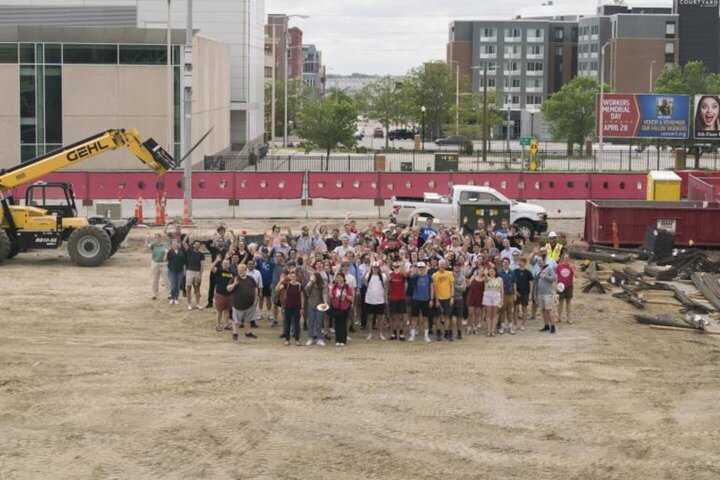 Students, faculty and staff in the Glenn Korff School of Music gathered for a group photo at the construction site for the new music building.