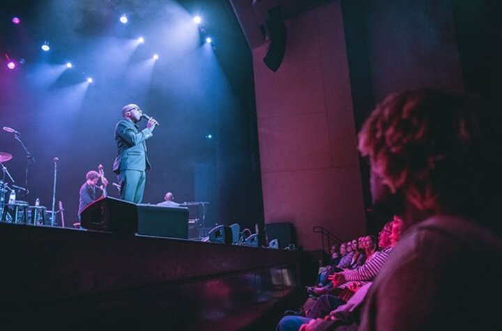 Student among an audience in the front row at the Lied Center during a concert