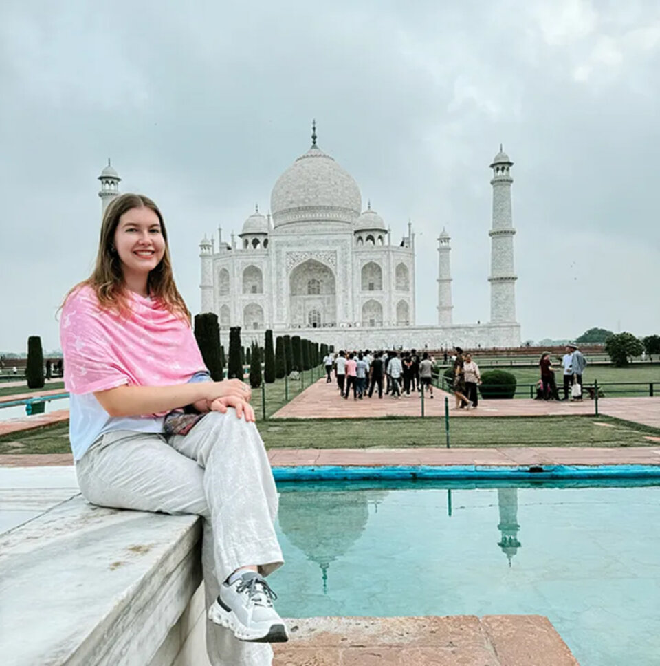 Hannah Gish sits in front of the Taj Mahal 