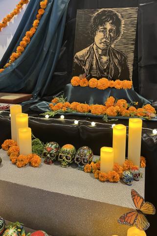 Angelica Tapia’s altar honoring Elvira C. Hernandez included a woodcut print of Hernandez. Courtesy photo.