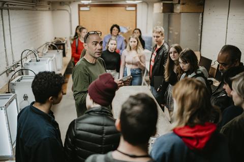 Associate Professor of Art Santiago Cal discusses the sculpture program with students from Lincoln Public Schools. Photo by Justin Mohling.