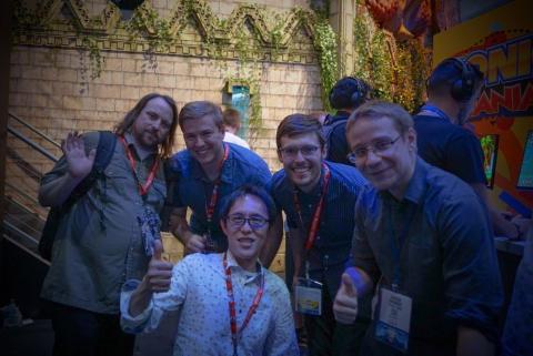Brad Flick (second from left) with the other members of the creative team pose with Naoto Ohshima (front), Sonic's original creator. 