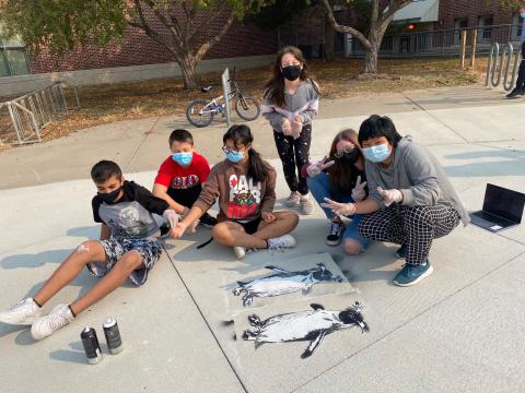 Students at Park Middle School created spray chalk animals such as this penguin from stencils as part of the “Stay Wild” community arts project, led by Associate Professor of Art Sandra Williams.