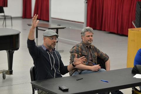 Nathan Tysen (left) and Chris Miller meet with students in the Glenn Korff School of Music. Photo by Michael Reinmiller.