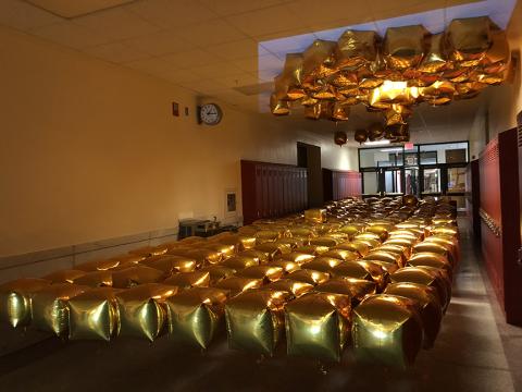 "Almost Disney" was built with 270 gold mylar balloons attached to the floor by fishing line so they appared to float waist-high, along with projection and sound inside a hallway. 
