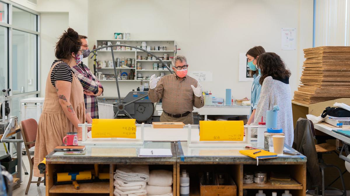 Graduate students work with Mark Dion to create an edition of prints.