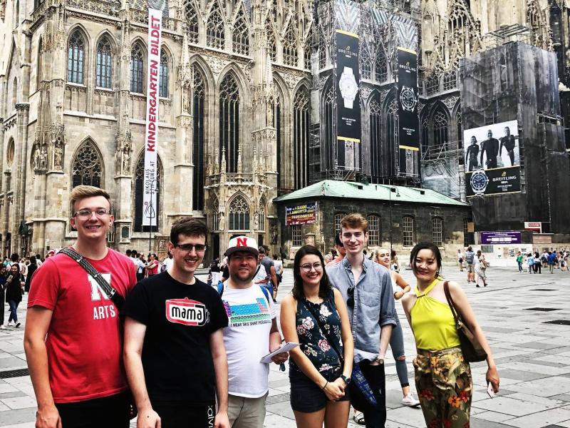 Six Glenn Korff School of Music pianists posing for a group picture in front of a cathedral in Vienna, Austria.