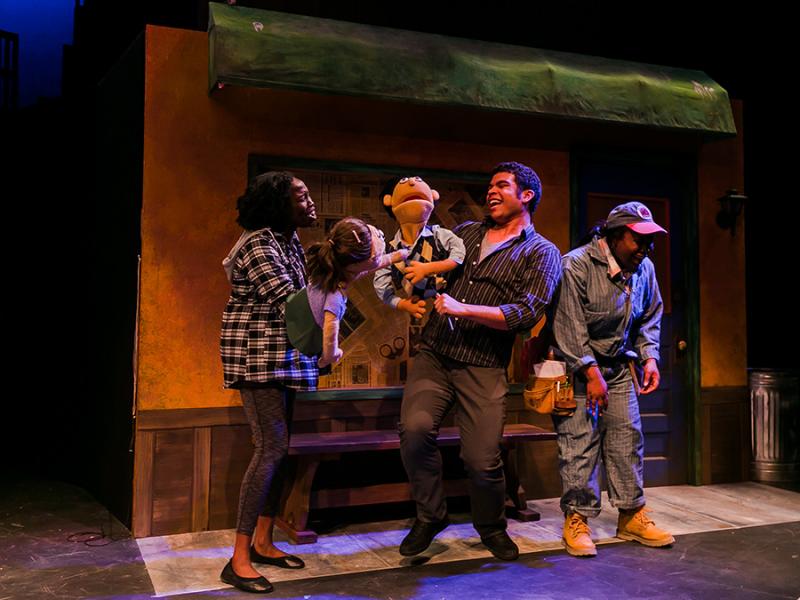 Theatre students on stage, performing in Nebraska Repertory Theatre’s production of 'Avenue Q.'