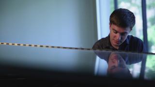 John performing at piano