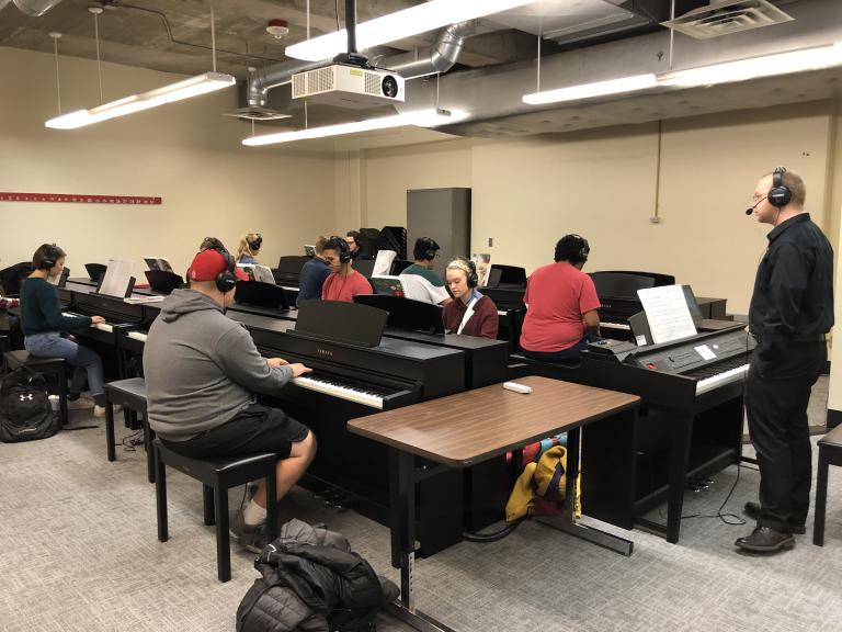 Students take part in a skills class in the large piano lab in Westbrook.