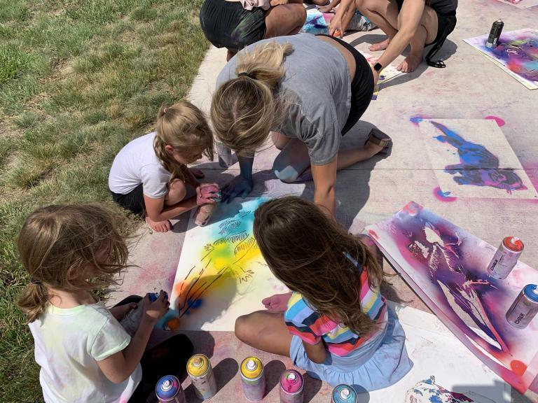Students in Alliance create spray chalk animals as part of the Stay Wild community arts project, led by Associate Professor of Art Sandra Williams. Courtesy photo.