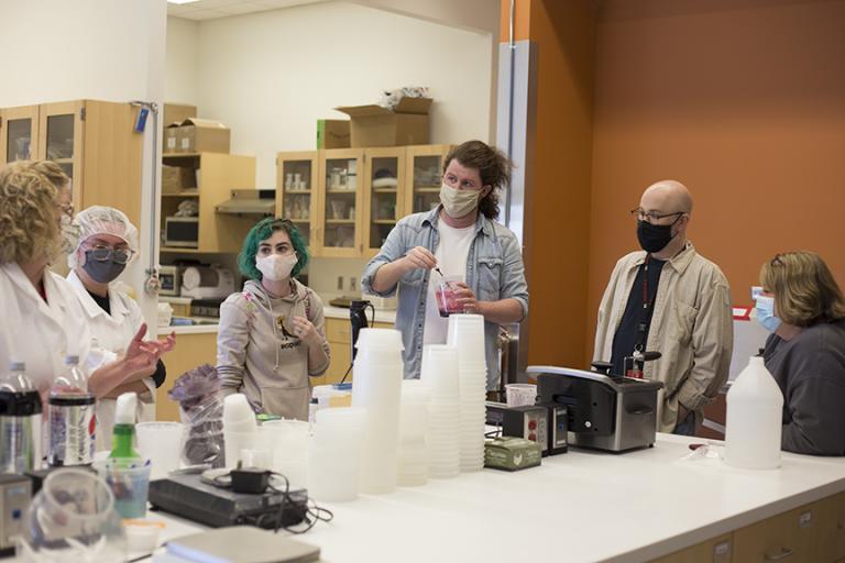 : (Left to right) Bethany Jackson, Zoe Kraus, Camille Lerner, Nathan Alexander, Jamie Bullins and Julie Reiling work on the perfect formula for the blood used in “Dracula: Mina’s Quest” at the Food Innovation Center. Photo by Eddy Aldana. 
