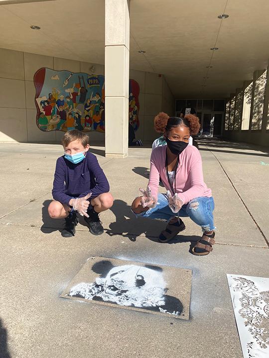 Students at Park Middle School in Lincoln created spray chalk animals from stencils as part of the “Stay Wild” community arts project.