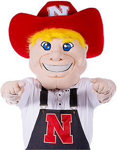 Herbie Husker smiles with both arms raised pointing to you, the site visitor.